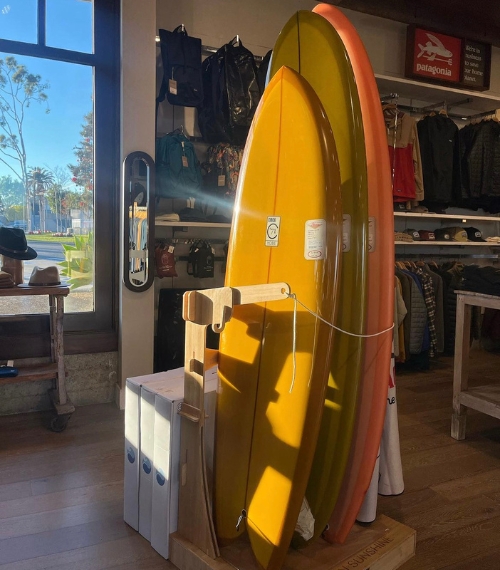 Image of shiny surfboards in a stand