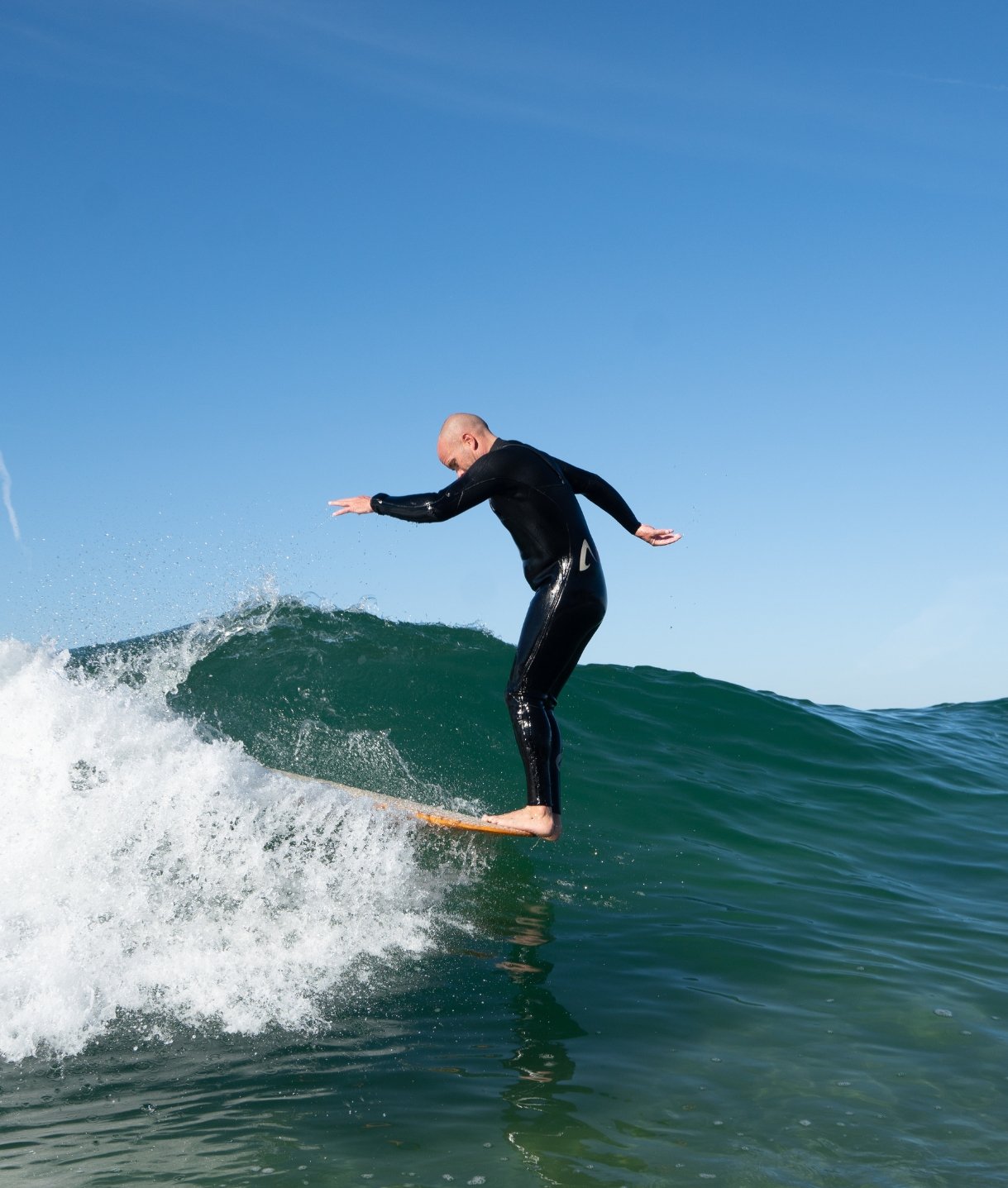 Image Of A Surfer In A Wetsuit