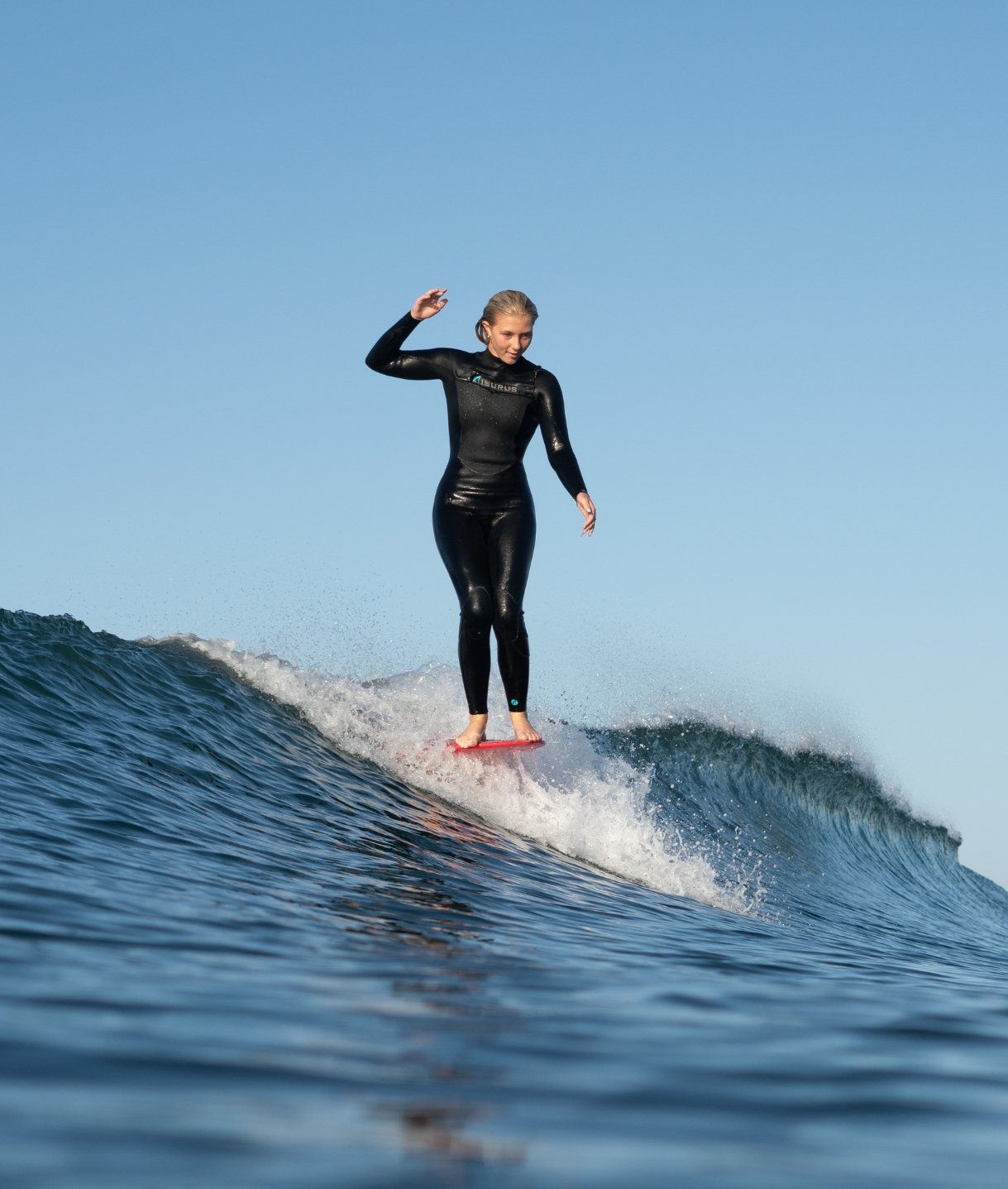 Image Of A Girl Surfing In A Westuit