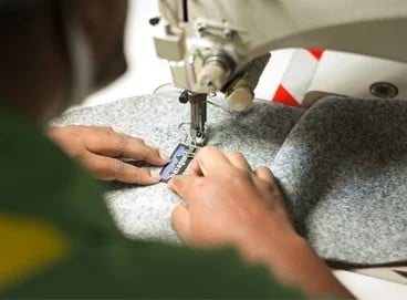 a patagonia patch being sewn on a jacket